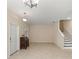 Bright living space with tile floors, staircase and neutral color palette at 14897 Evergreen Oak Loop, Winter Garden, FL 34787