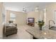 Bright living room boasts tile floors, modern ceiling fan, and comfortable seating area at 14897 Evergreen Oak Loop, Winter Garden, FL 34787