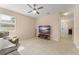 Comfortable living room has tile flooring, a ceiling fan, and a mounted television at 14897 Evergreen Oak Loop, Winter Garden, FL 34787