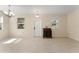 Spacious living room featuring tile flooring, ample natural light, and a welcoming entrance at 14897 Evergreen Oak Loop, Winter Garden, FL 34787