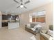 Open living area combines kitchen and lounge with tile floors, neutral decor, and natural light at 14897 Evergreen Oak Loop, Winter Garden, FL 34787