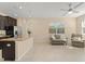 Bright open-concept living area featuring tile floors, a ceiling fan, and cozy furnishings at 14897 Evergreen Oak Loop, Winter Garden, FL 34787