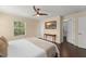 Cozy main bedroom features hardwood floors, ceiling fan, and a bright window at 14897 Evergreen Oak Loop, Winter Garden, FL 34787