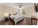 Serene main bedroom with hardwood floors, ceiling fan, and natural light at 14897 Evergreen Oak Loop, Winter Garden, FL 34787