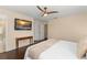 Comfortable main bedroom boasts hardwood floors, ceiling fan, and ample closet space at 14897 Evergreen Oak Loop, Winter Garden, FL 34787