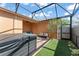 Serene screened patio offers a hot tub, ample seating, and a lush outdoor space at 14897 Evergreen Oak Loop, Winter Garden, FL 34787