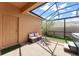Inviting screened patio with seating, landscaping, and hot tub at 14897 Evergreen Oak Loop, Winter Garden, FL 34787
