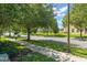 Scenic street view with mature trees lining the street and well-maintained sidewalks at 14897 Evergreen Oak Loop, Winter Garden, FL 34787