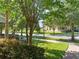 Neighborhood street view featuring mature landscaping and sidewalks, perfect for a relaxing stroll at 14897 Evergreen Oak Loop, Winter Garden, FL 34787