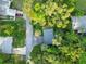 Aerial view showcases the property surrounded by lush trees at 1630 Lakeview Ct, Eustis, FL 32726