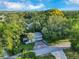 Aerial view of a home nestled among mature trees in a tranquil neighborhood at 1630 Lakeview Ct, Eustis, FL 32726