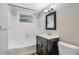 Cozy bathroom featuring a tub, shower, vanity with sink, toilet, and window providing natural light at 1630 Lakeview Ct, Eustis, FL 32726