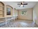 Bedroom featuring built-in shelves, herringbone floors, a ceiling fan, and two windows for natural light at 1630 Lakeview Ct, Eustis, FL 32726
