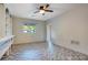 Bedroom featuring built-in shelves, herringbone floors, a ceiling fan, and a window for natural light at 1630 Lakeview Ct, Eustis, FL 32726