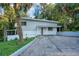 Charming two-story home featuring a modern design, complemented by lush tropical landscaping and a private driveway at 1630 Lakeview Ct, Eustis, FL 32726