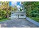 Charming two-story home featuring a modern design, complemented by lush tropical landscaping and a private driveway at 1630 Lakeview Ct, Eustis, FL 32726