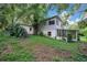 Two-story home surrounded by mature trees and lush greenery creating a private and serene setting at 1630 Lakeview Ct, Eustis, FL 32726