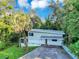 Well-maintained two-story home with a palm tree and a driveway at 1630 Lakeview Ct, Eustis, FL 32726