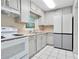 Bright kitchen featuring white cabinetry, stainless steel appliances, and a window offering natural light at 1630 Lakeview Ct, Eustis, FL 32726