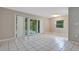 Spacious living room featuring white tile floors and sliding glass doors leading to an outdoor patio at 1630 Lakeview Ct, Eustis, FL 32726