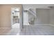 Bright open-plan living space with tile flooring, leading to the kitchen and featuring a staircase at 1630 Lakeview Ct, Eustis, FL 32726