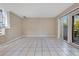 Bright living space featuring tiled floors, neutral walls, and access to outdoor area through sliding doors at 1630 Lakeview Ct, Eustis, FL 32726