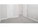 Carpeted bedroom with two doors and base trim at 16526 Silver Brook Way, Winter Garden, FL 34787
