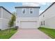 Two-story house featuring a brick driveway, green lawn, and blue cladding on the second floor at 16526 Silver Brook Way, Winter Garden, FL 34787