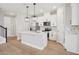 Modern kitchen featuring white cabinets, island, and stainless steel appliances at 16526 Silver Brook Way, Winter Garden, FL 34787