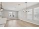 Sunlit living area showcasing modern light fixtures and expansive windows at 16526 Silver Brook Way, Winter Garden, FL 34787