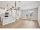 Spacious living area adjoining the kitchen, featuring modern light fixtures and hardwood floors at 16526 Silver Brook Way, Winter Garden, FL 34787