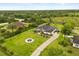 Expansive aerial view of a large home with a long driveway and well-manicured lawn surrounded by lush greenery at 18920 Overton St, Orlando, FL 32833