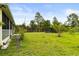 Spacious backyard features lush green grass and a screened patio for outdoor relaxation at 18920 Overton St, Orlando, FL 32833