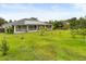 Large backyard with a home featuring solar panels, and a screened lanai at 18920 Overton St, Orlando, FL 32833