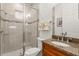 Bathroom with granite countertop, tiled floors, and a glass enclosed shower with wall mounted shower head at 18920 Overton St, Orlando, FL 32833