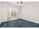 Bright bedroom features a ceiling fan, window with sheer curtains, and neutral paint at 18920 Overton St, Orlando, FL 32833