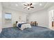 Large bedroom featuring plush blue carpet, neutral walls, and a ceiling fan at 18920 Overton St, Orlando, FL 32833