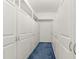 Walk-in closet with custom built-ins and soft blue carpeting at 18920 Overton St, Orlando, FL 32833