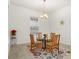 Cozy dining area with a glass top table, seating for four and a floral area rug at 18920 Overton St, Orlando, FL 32833
