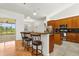 Kitchen featuring bar seating, stainless steel appliances, and dark countertops at 18920 Overton St, Orlando, FL 32833