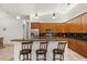 Modern kitchen with stainless steel appliances, a breakfast bar, and dark backsplash at 18920 Overton St, Orlando, FL 32833