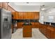 Spacious kitchen featuring stainless appliances, cherry wood cabinets, and center island at 18920 Overton St, Orlando, FL 32833