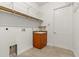 Functional laundry room includes a utility sink, storage shelves, and a tiled floor at 18920 Overton St, Orlando, FL 32833