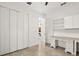 Office area with tiled floor, custom cabinets, and a large closet for extra storage at 18920 Overton St, Orlando, FL 32833