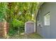 Backyard with a small storage shed by lush trees and next to gray house at 1921 Dartmouth Ave, Winter Park, FL 32789