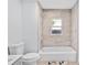 Bright bathroom featuring a tiled shower and tub combo, complemented by modern fixtures and natural light at 1921 Dartmouth Ave, Winter Park, FL 32789