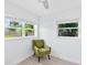 Bright bedroom featuring two windows and a comfortable green armchair at 1921 Dartmouth Ave, Winter Park, FL 32789