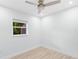 Bright bedroom featuring a window, clean white walls, and light hardwood flooring at 1921 Dartmouth Ave, Winter Park, FL 32789