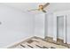 Bright bedroom featuring a ceiling fan, clean white walls, and light hardwood flooring at 1921 Dartmouth Ave, Winter Park, FL 32789