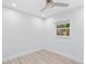 A cozy bedroom features light wood floors, recessed lighting, and a ceiling fan for added comfort at 1921 Dartmouth Ave, Winter Park, FL 32789